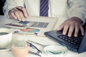 Businessman is working on a table with a functional device is placed. photo