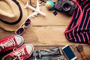 Travel accessories and costume on wooden floor photo
