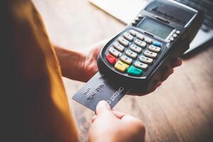 Paying by credit card , buying and selling products using a credit card swipe machine photo