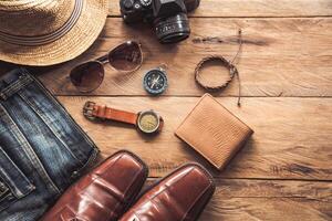 Travel Clothing accessories for men on wooden floor photo