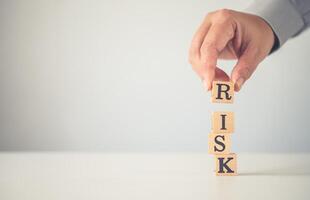 Hand hold wooden block with the word RISK. Concept risk photo