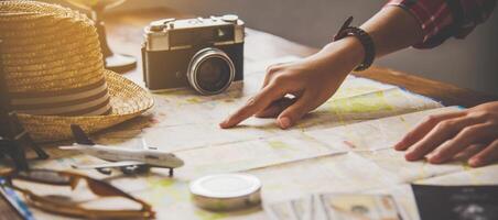 Travelers are planning a trip by searching the route on the map and searching for information on the internet. photo