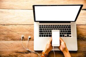 topview businessmen use smartphones and laptop to connect and find information in office photo