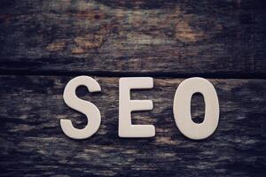 Place the word  S E O on the wooden floor - concept Search Engine Optimization photo