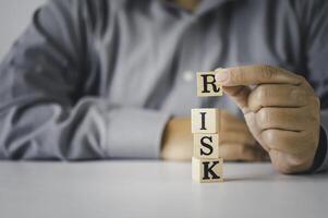 Hand hold wooden block with the word RISK Concept risk photo