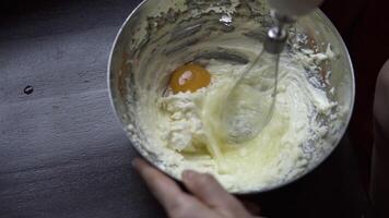 The cook stirs the egg with a whisk in a bowl video