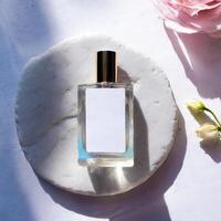 Mockup of galss transparent perfume bottle on stone plate and shadows photo
