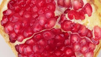 Juicy pomegranate cut in half isolated on white background, clipping path. Ripe fruit is a healthy food. video