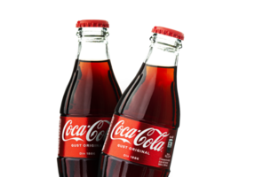 Two classic bottles of Coca-Cola isolated on a transparent background png