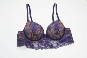 Lingerie. Beautiful sexy lace purple lilac bra on a white background. Fashionable colored women's underwear. photo