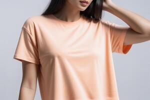 AI generated Woman in peach fuzz colored tshirt, can be used for design, mock up. The trending color of 2024. photo