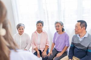 senior females and male sitting on bench. older people are listening and enjoy meeting focus group at living room. Joyful carefree retired senior friends enjoying relaxation at nearly home. photo