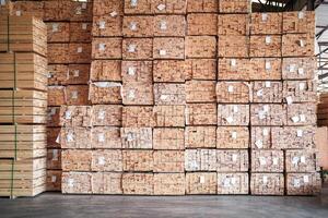 background of pattern wood section. Grid of wood squares. the raw of material timber on stack. photo