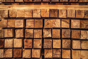 background of pattern wood section. Grid of wood squares. the raw of material timber on stack. photo