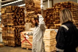 man workers engineering standing with confidence with working suite dress and hand glove in front machine. Concept of smart industry worker operating. Wood factory produce wood palate. photo