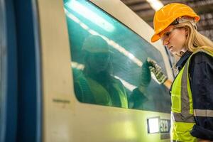 Factory engineer woman standing confidence to control panel switch. Worker works at heavy machine at industry factory. with machinery equipment plant technology. smart industry worker operating. photo