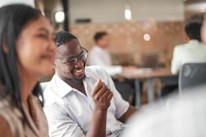 focus of smart african businessman. Diverse employees gathered in office having fun brainstorming while discussing new ideas project. Multiracial coworkers meeting at coworking space area. photo