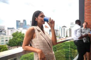 African business smart woman stands at outdoor terrace building. people with on hand in good feeling with city space building. relaxing of people business morning. photo