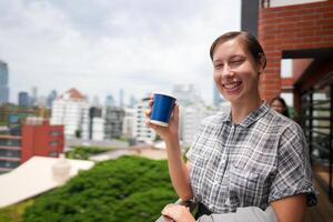 African business smart woman stands at outdoor terrace building. people with on hand in good feeling with city space building. relaxing of people business morning. photo