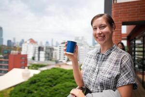 African business smart woman stands at outdoor terrace building. people with on hand in good feeling with city space building. relaxing of people business morning. photo