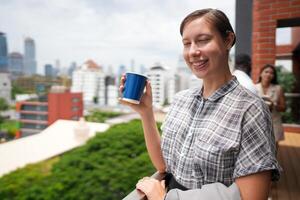 African business smart woman stands at outdoor terrace building. people with on hand in good feeling with city space building. relaxing of people business morning. photo