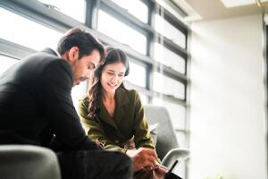 Business people having fun and chatting at workplace office. Male and female colleague enjoy meeting at co working space. colleagues discussing about the project in the office. photo