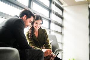 Business people having fun and chatting at workplace office. Male and female colleague enjoy meeting at co working space. colleagues discussing about the project in the office. photo