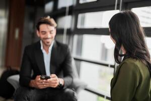 Business people having fun and chatting at workplace office. Male and female colleague enjoy meeting at co working space. colleagues discussing about the project in the office. photo