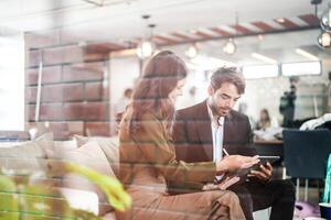 Business people talking at workplace office. Male and female colleagues enjoy relaxing and sitting on sofa. colleagues discussing about the project in the office. team of young people in office. photo