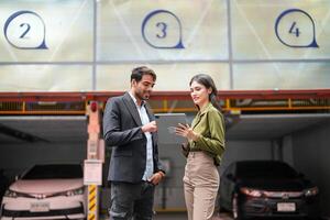 Professional salesperson woman selling cars to businessman buyer. Car Sales. Manager Giving suggestions to Businessman Buyer In garage parking Dealership Shop. Car dealer sales consultant. photo
