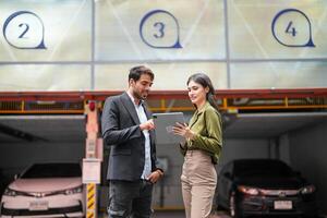 Professional salesperson woman selling cars to businessman buyer. Car Sales. Manager Giving suggestions to Businessman Buyer In garage parking Dealership Shop. Car dealer sales consultant. photo