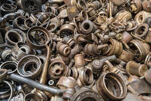 rusted steel scrap pile of used car parts and pieces photo