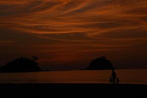 Couple holding hands at sunset photo