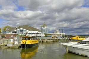 Alexandria, VA, USA 2023. Yellow Potomac cruiser boats moared at the Old Town waterfront in Alexandria VA photo