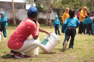 Magelang,Indonesia,12 07 2023.outdoor teaching and learning activities for young children, interaction with nature and teachers using play methods. photo