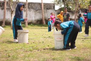 Magelang,Indonesia,12 07 2023.outdoor teaching and learning activities for young children, interaction with nature and teachers using play methods. photo