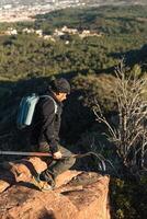 Man descends the mountain surrounded by the landscape of the Garraf Natural Park. photo