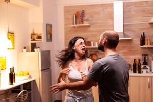 Bruised wife fighting violent husband and screaming in dispair. Traumatised helpless terrified vulnerable wifes uffering injury from agressive alcoholoic brutal man . photo