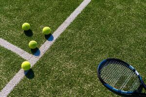 View of empty lawn tennis court with tennis ball photo