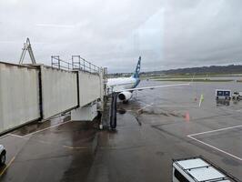 PORTLAND, USA - 12.10.2023 Interior Portland Airport. View from the window of planes and passengers boarding. photo