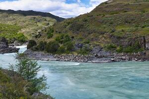 Rapids at the confluence of blue Baker river and grey Neff river, Pan-American Highway between Cochrane and Puerto Guadal, Aysen Region, Patagonia, Chile photo