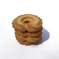 A pile of brownish-colored Cookies isolated on a white background. photo
