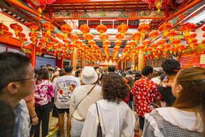 Atmosphere inside Wat Mangkon Kamalawat ,Leng Neey Yi. People come to worship and pray for blessings from in Wat Mangkon. Chinese New Year on Yaowarat Road photo