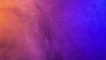 Beautiful and colorful abstract moving clouds over a black background in studio video