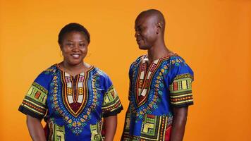 African american partners giving thumbs up gesture in studio, feeling cheerful and presenting their positive feedback. Married couple showing approval and doing like symbol on camera. video