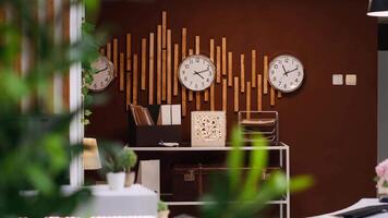 Empty front desk and lobby at luxurious vacation resort with clocks showing different international time zones. Modern reception and lounge area ready for guests and travelers, hospitality industry. video