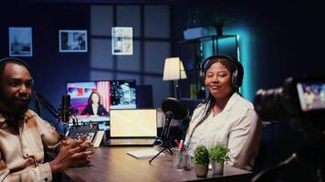 African american influencers in studio using high tech camera for internet show production on livestreaming channel. Vloggers partners doing podcasting session with professional video gear