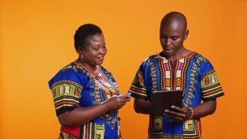 African american couple buying clothes on sale with web payment, enjoying online shopping session using tablet. Young married people looking for items on store website or app, mobile gadget. video