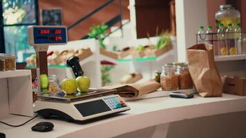 Supermarket electronic scale used to weight bulk items and organic freshly harvested produce, nonpolluting sustainable lifestyle. Empty grocery store selling homemade supplies. Handheld shot. video