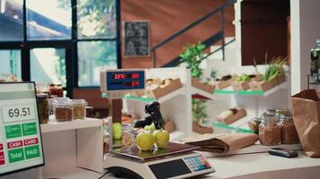 Grocery store scale used to sell bulk items and weight goods at cash register checkout, sustainable lifestyle. Market with freshly harvested produce and homemade pantry essentials. Handheld shot. video